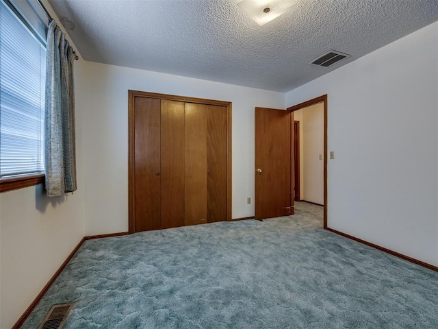 4004 N Shannon Ave, Bethany, OK 73008 - unfurnished bedroom with a closet, carpet, a textured ceiling, and baseboards