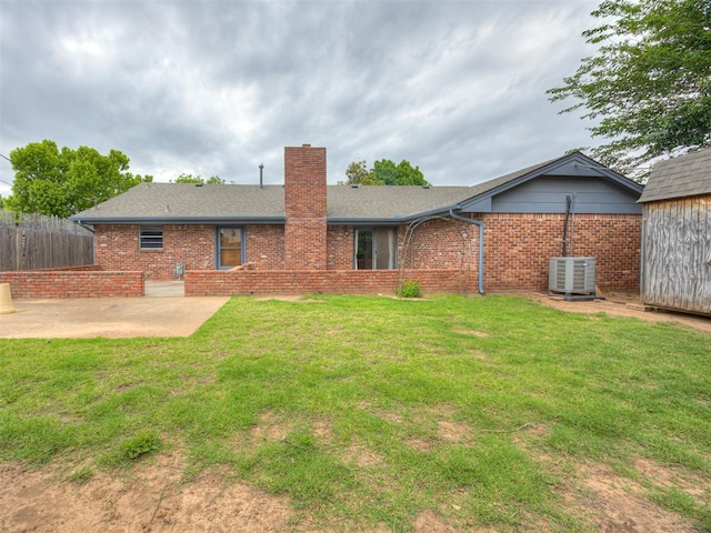 4004 N Shannon Ave, Bethany, OK 73008 - rear view of property with brick siding, a patio, a chimney, cooling unit, and a shingled roof