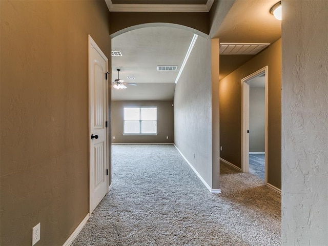7909 Dawn Cir, Oklahoma City, OK 73135 - corridor featuring arched walkways, carpet floors, a textured wall, crown molding, and baseboards