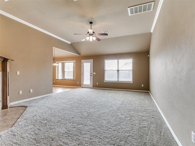 7909 Dawn Cir, Oklahoma City, OK 73135 - unfurnished living room featuring ceiling fan, healthy amount of natural light, crown molding, carpet flooring, and vaulted ceiling