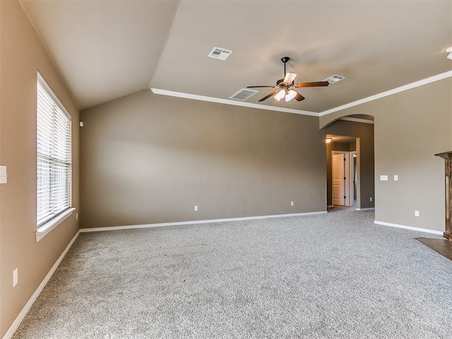 7909 Dawn Cir, Oklahoma City, OK 73135 - carpeted empty room with a ceiling fan, arched walkways, baseboards, ornamental molding, and lofted ceiling