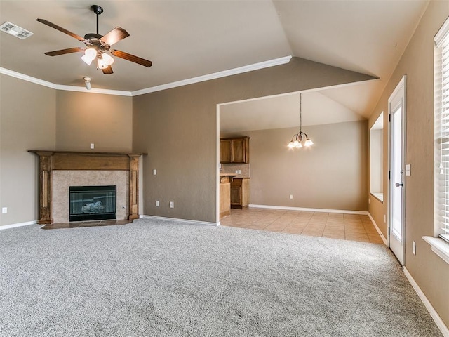 7909 Dawn Cir, Oklahoma City, OK 73135 - unfurnished living room featuring light colored carpet, a ceiling fan, lofted ceiling, a tile fireplace, and a chandelier