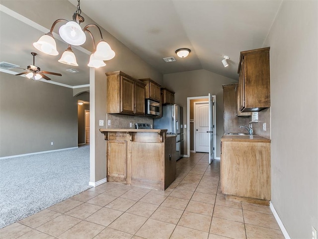 7909 Dawn Cir, Oklahoma City, OK 73135 - kitchen featuring stainless steel appliances, a ceiling fan, a sink, light tile patterned flooring, and decorative backsplash