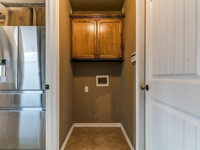 7909 Dawn Cir, Oklahoma City, OK 73135 - washroom featuring washer hookup, baseboards, cabinet space, and tile patterned floors