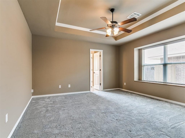 7909 Dawn Cir, Oklahoma City, OK 73135 - unfurnished room featuring a raised ceiling, carpet floors, ceiling fan, baseboards, and crown molding