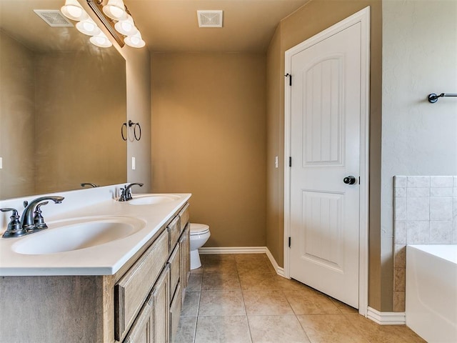 7909 Dawn Cir, Oklahoma City, OK 73135 - bathroom with double vanity, toilet, a bath, tile patterned flooring, and baseboards