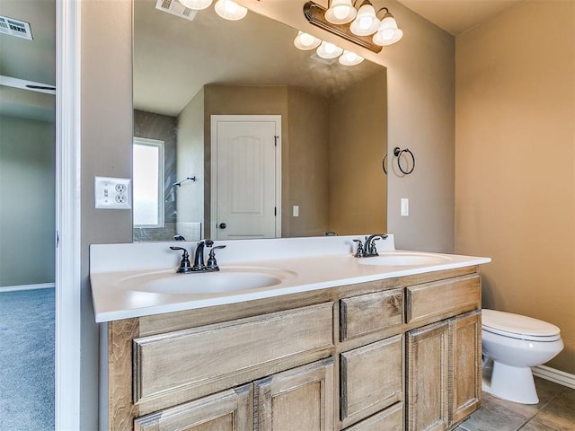 7909 Dawn Cir, Oklahoma City, OK 73135 - bathroom with double vanity, toilet, and baseboards