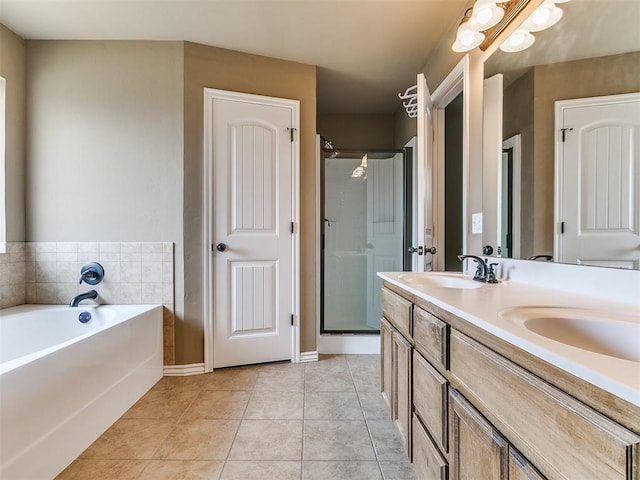 7909 Dawn Cir, Oklahoma City, OK 73135 - full bathroom featuring a garden tub, double vanity, a shower stall, tile patterned floors, and baseboards