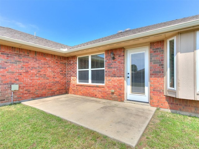 7909 Dawn Cir, Oklahoma City, OK 73135 - entrance to property featuring a patio, brick siding, and a shingled roof