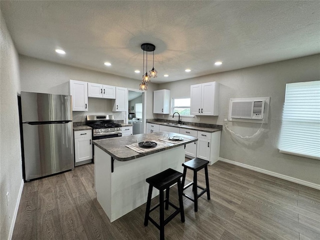 214 N 3rd St, Sentinel, OK 73664 - kitchen with stainless steel appliances, a sink, dark wood-style flooring, washer / clothes dryer, and recessed lighting