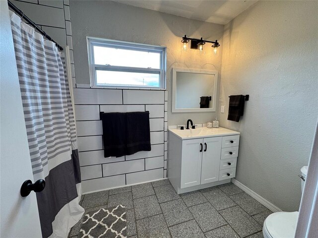 214 N 3rd St, Sentinel, OK 73664 - bathroom with toilet, vanity, and baseboards
