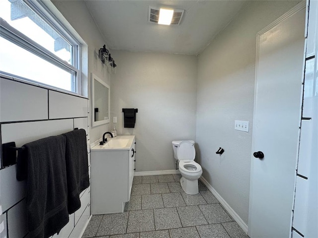214 N 3rd St, Sentinel, OK 73664 - bathroom with vanity, toilet, and baseboards