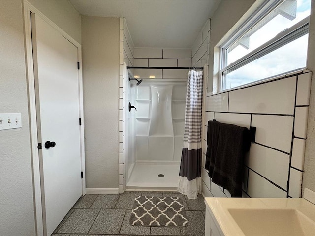 214 N 3rd St, Sentinel, OK 73664 - full bathroom featuring a stall shower, baseboards, and vanity