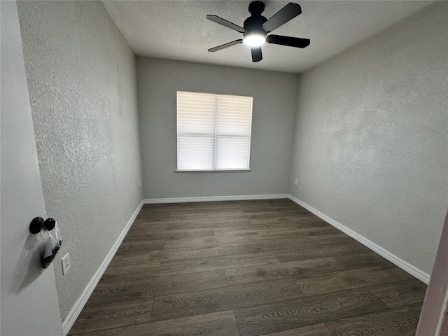 214 N 3rd St, Sentinel, OK 73664 - unfurnished room with a textured wall, dark wood finished floors, ceiling fan, and baseboards