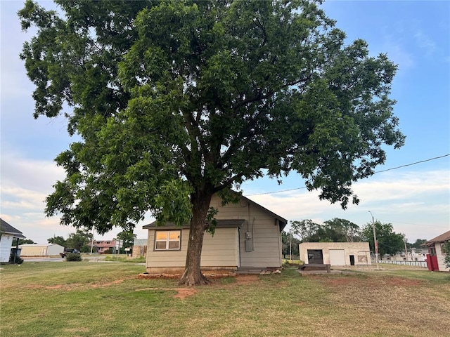214 N 3rd St, Sentinel, OK 73664 - view of property exterior featuring a lawn and a garage