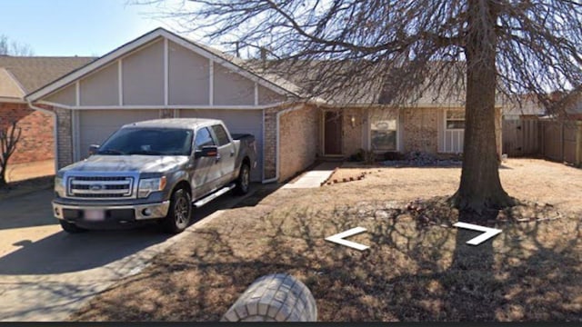 908 Linn Ln, Yukon, OK 73099 - view of front of home with a garage, brick siding, and driveway