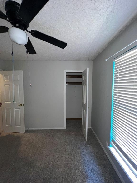 908 Linn Ln, Yukon, OK 73099 - unfurnished bedroom featuring a textured ceiling, a closet, carpet flooring, baseboards, and a ceiling fan
