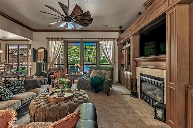 1322 Mockingbird Ln, Guthrie, OK 73044 - living room featuring light carpet, ornamental molding, ceiling fan, and a fireplace