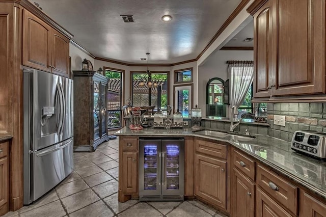 1322 Mockingbird Ln, Guthrie, OK 73044 - kitchen featuring stainless steel refrigerator with ice dispenser, wine cooler, a sink, a peninsula, and dark stone counters