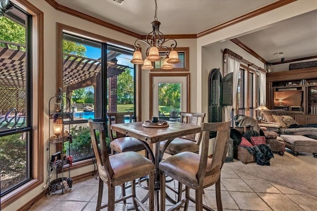 1322 Mockingbird Ln, Guthrie, OK 73044 - dining space with a chandelier, ornamental molding, stone tile floors, and baseboards