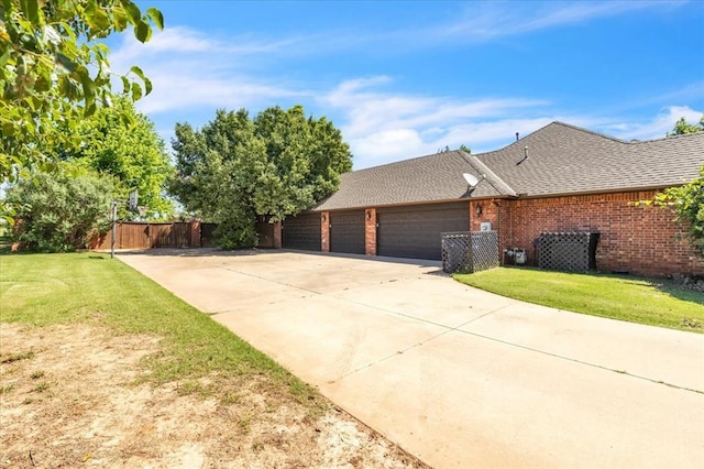 1322 Mockingbird Ln, Guthrie, OK 73044 - view of front of property featuring driveway, a garage, roof with shingles, and brick siding
