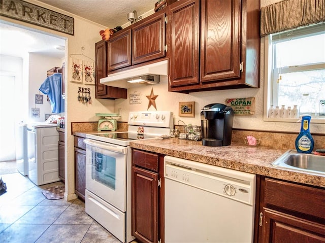 920245 S 3300th Rd, Wellston, OK 74881 - kitchen featuring white appliances, under cabinet range hood, separate washer and dryer, a textured ceiling, and light countertops
