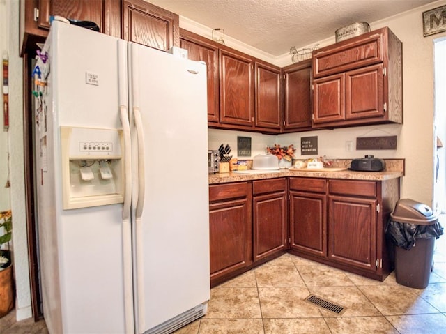 920245 S 3300th Rd, Wellston, OK 74881 - kitchen with white refrigerator with ice dispenser, light countertops, light tile patterned floors, and a textured ceiling