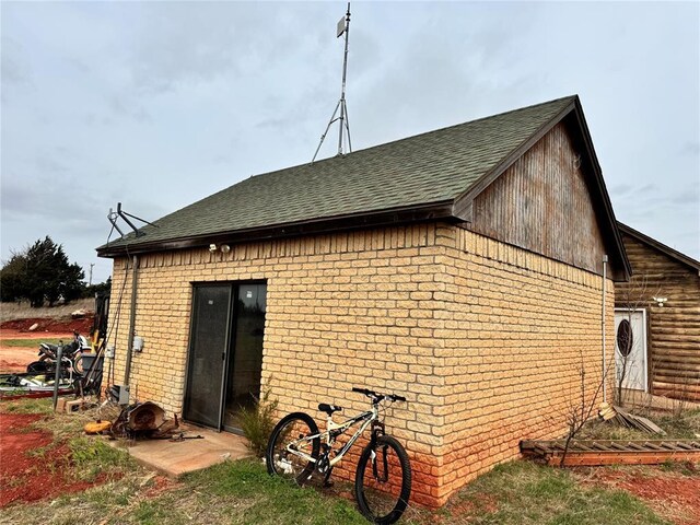2862 S Indian Meridian Rd, Meridian, OK 73058 - rear view of house with brick siding and a shingled roof