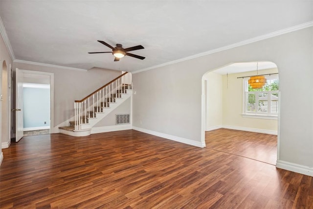 1535 NW 39th St, Oklahoma City, OK 73118 - unfurnished living room featuring arched walkways, wood finished floors, stairway, a ceiling fan, and ornamental molding