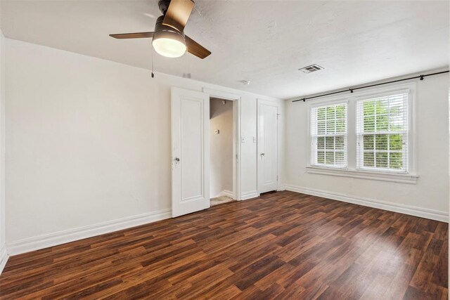 1535 NW 39th St, Oklahoma City, OK 73118 - unfurnished bedroom featuring dark wood-type flooring, baseboards, and ceiling fan