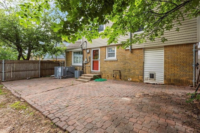 1535 NW 39th St, Oklahoma City, OK 73118 - back of house with brick siding, a patio, and central air condition unit