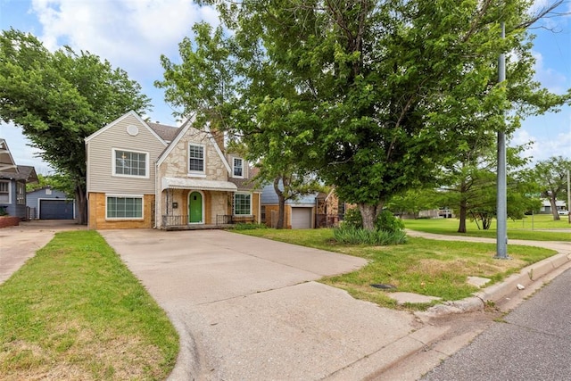 1535 NW 39th St, Oklahoma City, OK 73118 - view of front of home featuring stone siding, a front lawn, driveway, and an outdoor structure