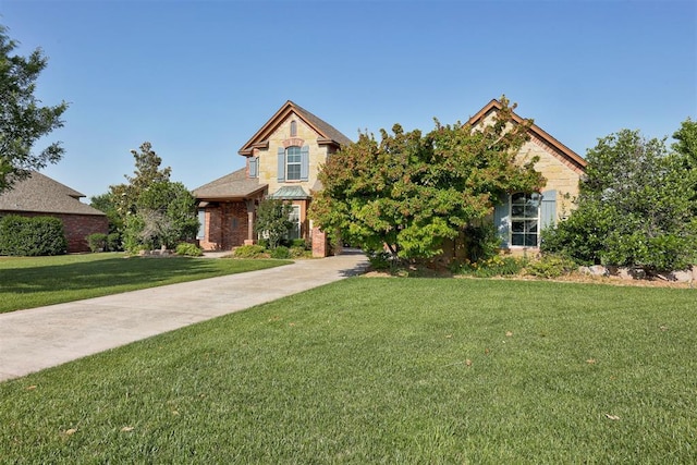 5905 Smoky Hill Trl, Edmond, OK 73034 - view of property hidden behind natural elements with stone siding and a front yard