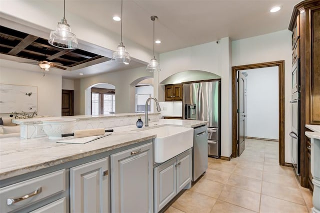 5905 Smoky Hill Trl, Edmond, OK 73034 - kitchen with a sink, stainless steel appliances, coffered ceiling, recessed lighting, and arched walkways