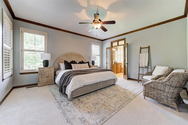 5905 Smoky Hill Trl, Edmond, OK 73034 - bedroom with light carpet, baseboards, ornamental molding, ceiling fan, and connected bathroom