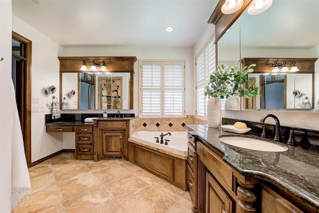 5905 Smoky Hill Trl, Edmond, OK 73034 - bathroom featuring a garden tub, two vanities, and baseboards