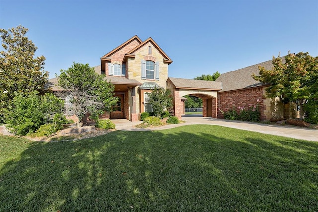 5905 Smoky Hill Trl, Edmond, OK 73034 - view of front of property with a front lawn, brick siding, stone siding, and a shingled roof
