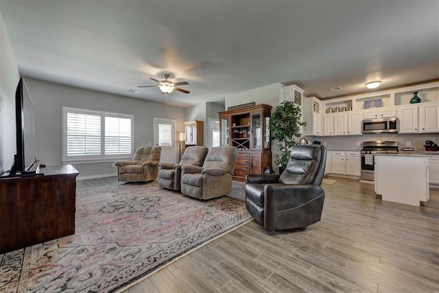 11734 Split Oak Cir, Guthrie, OK 73044 - living room featuring ceiling fan, light wood-style floors, and baseboards