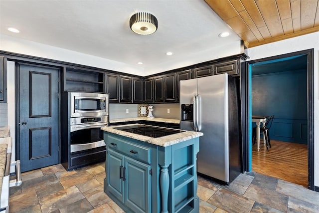 2208 Amber Rd, Oklahoma City, OK 73170 - kitchen featuring appliances with stainless steel finishes, open shelves, a kitchen island, stone finish flooring, and recessed lighting