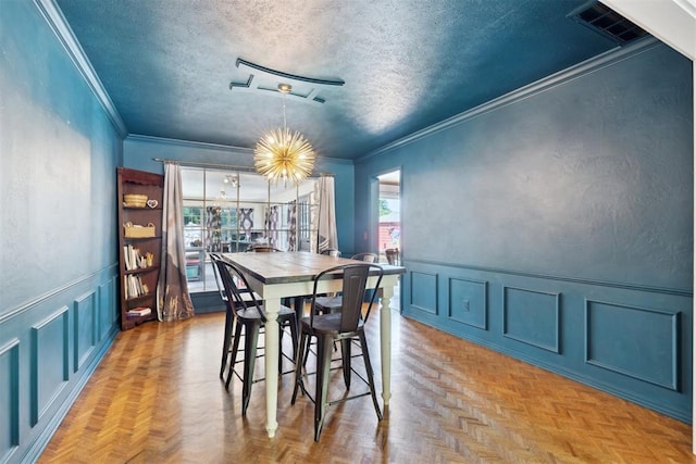 2208 Amber Rd, Oklahoma City, OK 73170 - dining area featuring a decorative wall, crown molding, a textured ceiling, and a wainscoted wall