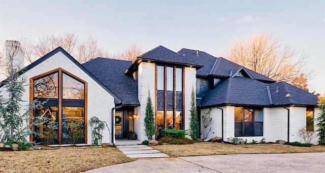 4420 Trophy Dr, Norman, OK 73072 - view of front facade featuring brick siding, roof with shingles, and a chimney