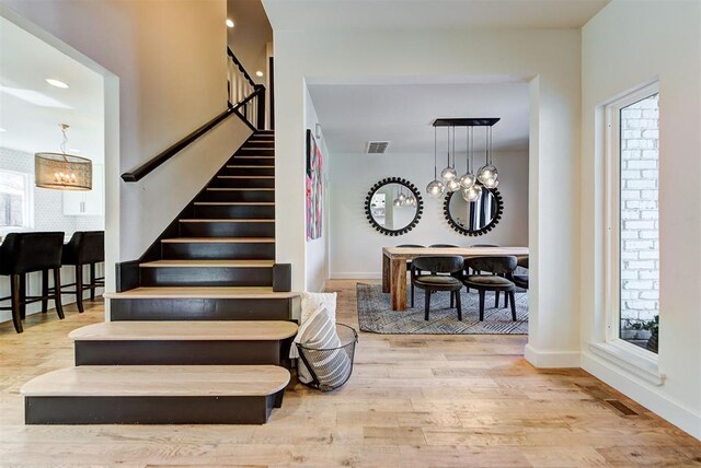 4420 Trophy Dr, Norman, OK 73072 - stairway featuring a chandelier, wood finished floors, and baseboards