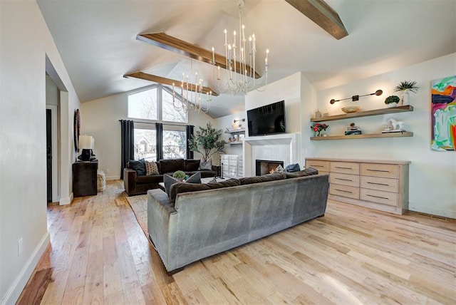 4420 Trophy Dr, Norman, OK 73072 - living room featuring a chandelier, a warm lit fireplace, light wood finished floors, and baseboards