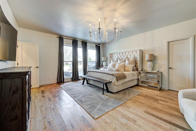 4420 Trophy Dr, Norman, OK 73072 - bedroom with a chandelier, light wood finished floors, and baseboards