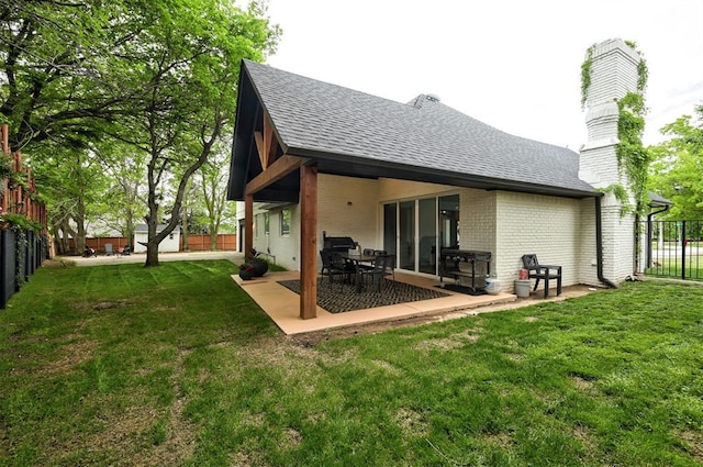 4420 Trophy Dr, Norman, OK 73072 - back of property with roof with shingles, brick siding, a patio area, and a chimney