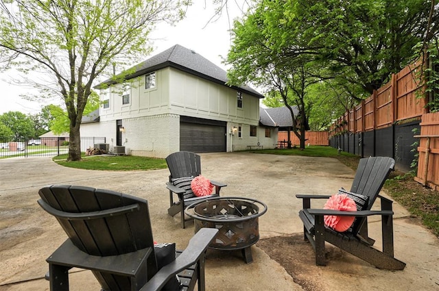 4420 Trophy Dr, Norman, OK 73072 - view of patio / terrace featuring an outdoor fire pit, a garage, driveway, and central AC