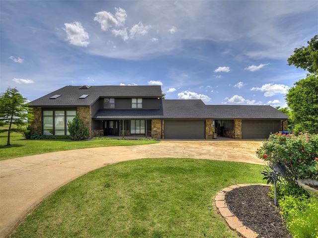 19005 Aerial Rd, Edmond, OK 73012 - view of front facade featuring concrete driveway, stone siding, an attached garage, and a front yard