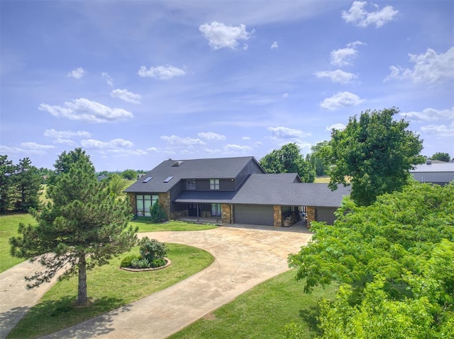 19005 Aerial Rd, Edmond, OK 73012 - mid-century inspired home with an attached garage, curved driveway, a front yard, a shingled roof, and stone siding