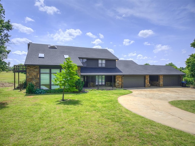 19005 Aerial Rd, Edmond, OK 73012 - view of front of property featuring stone siding, a garage, concrete driveway, a front lawn, and roof with shingles