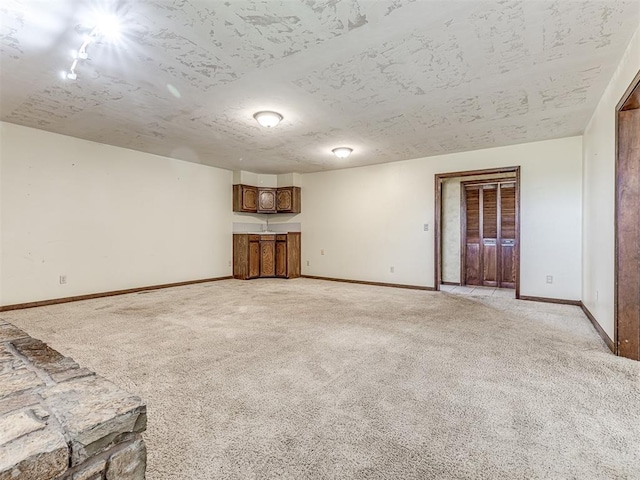 19005 Aerial Rd, Edmond, OK 73012 - unfurnished living room with light carpet and baseboards